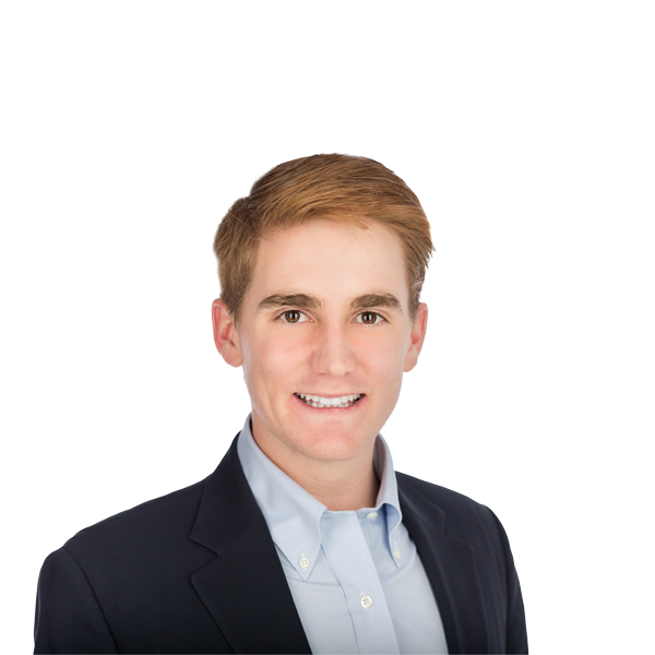 redhead man in a suit smiling for the photo