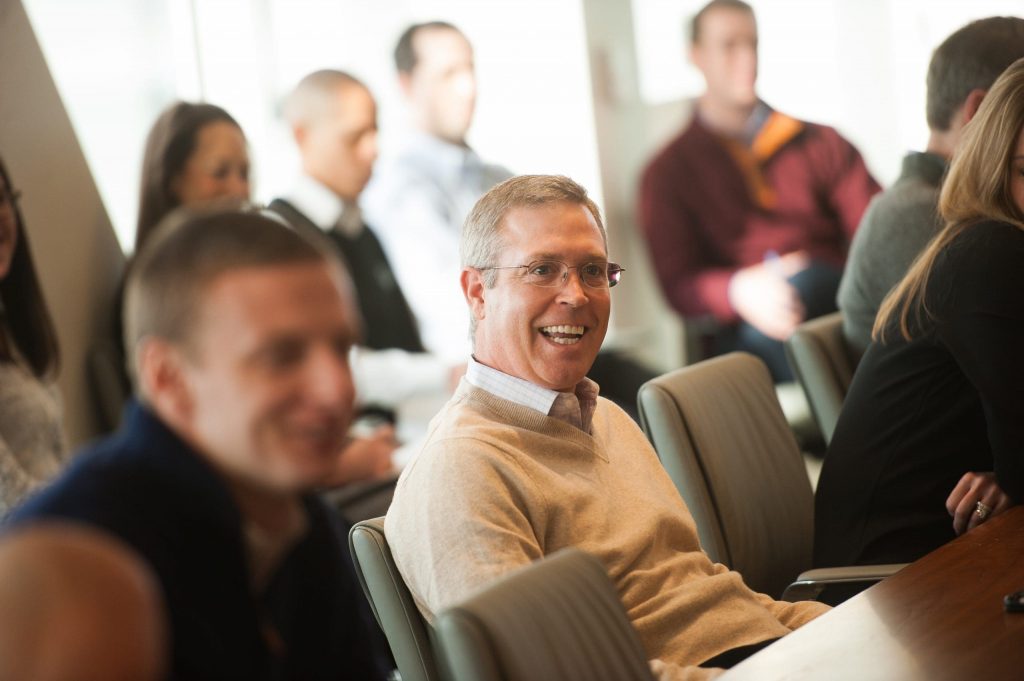 man with glasses is smiling