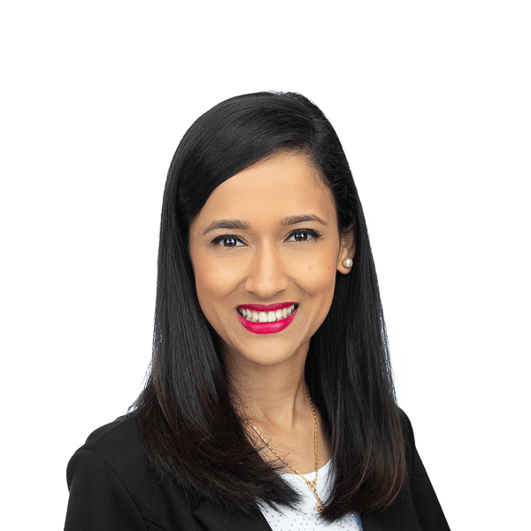 a woman with black hair wearing a black jacket and a white t-shirt smiles at the camera