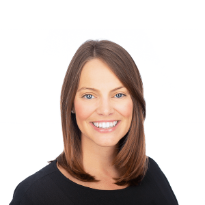 a woman with brown hair with blue eyes wearing a black shirt smiles at the camera