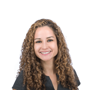 woman in light curly hair in a black t-shirt smiles at the camera