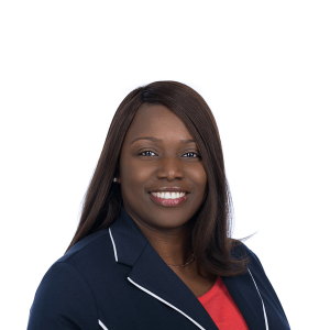 a black woman in a red blouse smiles at the camera