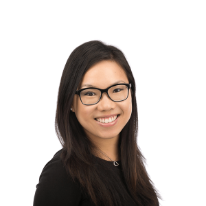 asian woman with necklace in black blouse smiles at camera