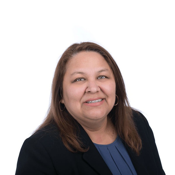 woman in brown hair in a black jacket and navy blue shirt smiles at the camera