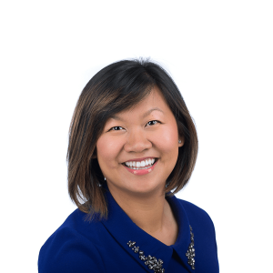 short-cut woman in a navy blue t-shirt smiles at the camera