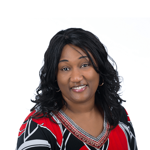 a woman with black hair wearing gold earrings wearing a colorful shirt smiles at the camera