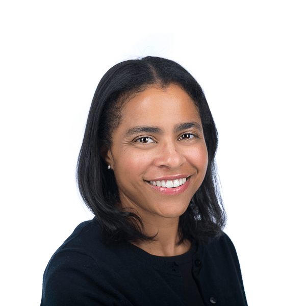 a black woman with brown eyes and black hair in a black blouse smiles at the camera