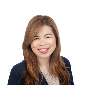 asian redhead woman wearing a black jacket and a colorful t-shirt smiles at the camera