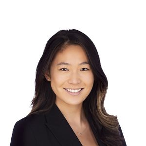 a woman with dark hair smiling at the camera