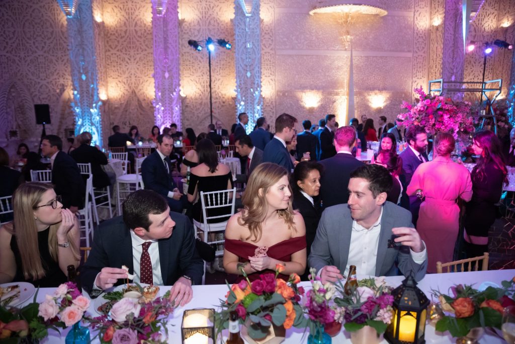 people at the party are chatting while sitting at the table