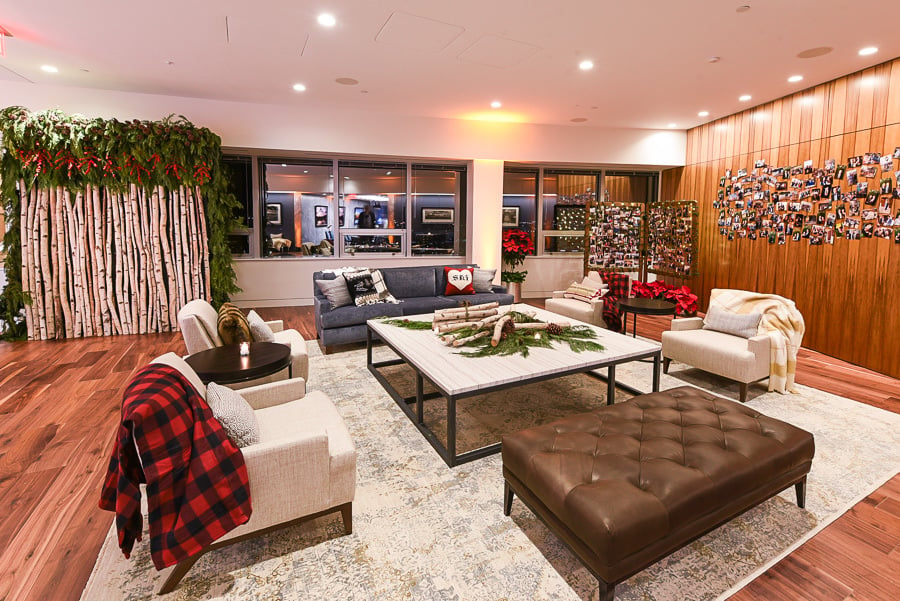 spacious room with large white armchairs with checkered blankets