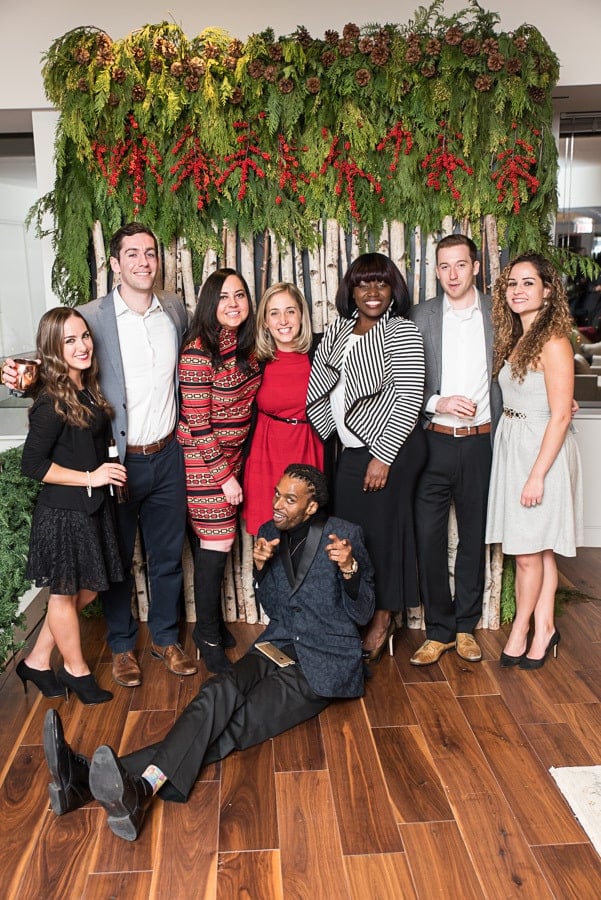 a group of people is posing for a picture and smiling at the camera