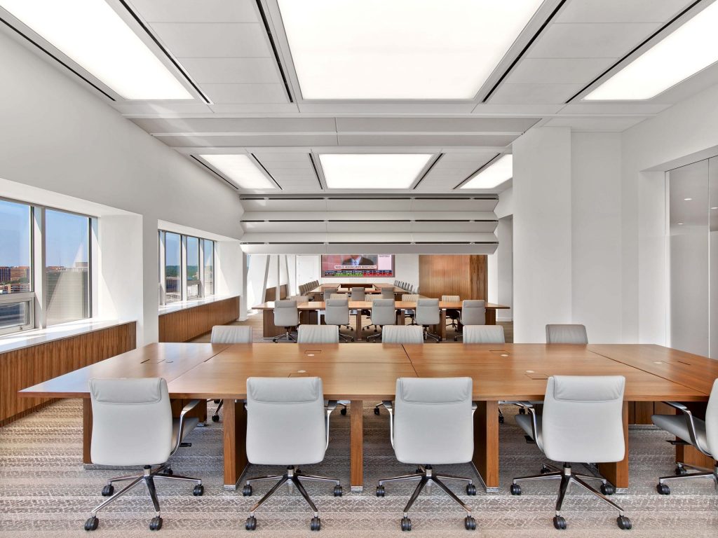 office with white chairs large tables and city views