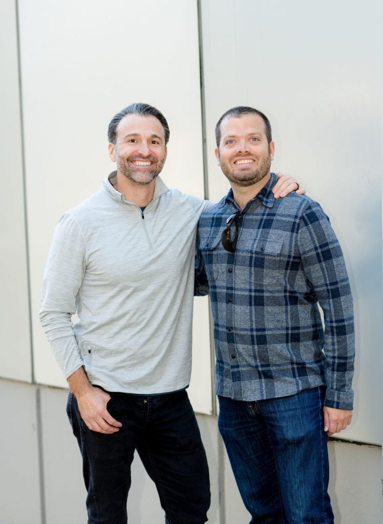 Two man standing and posing for the picture