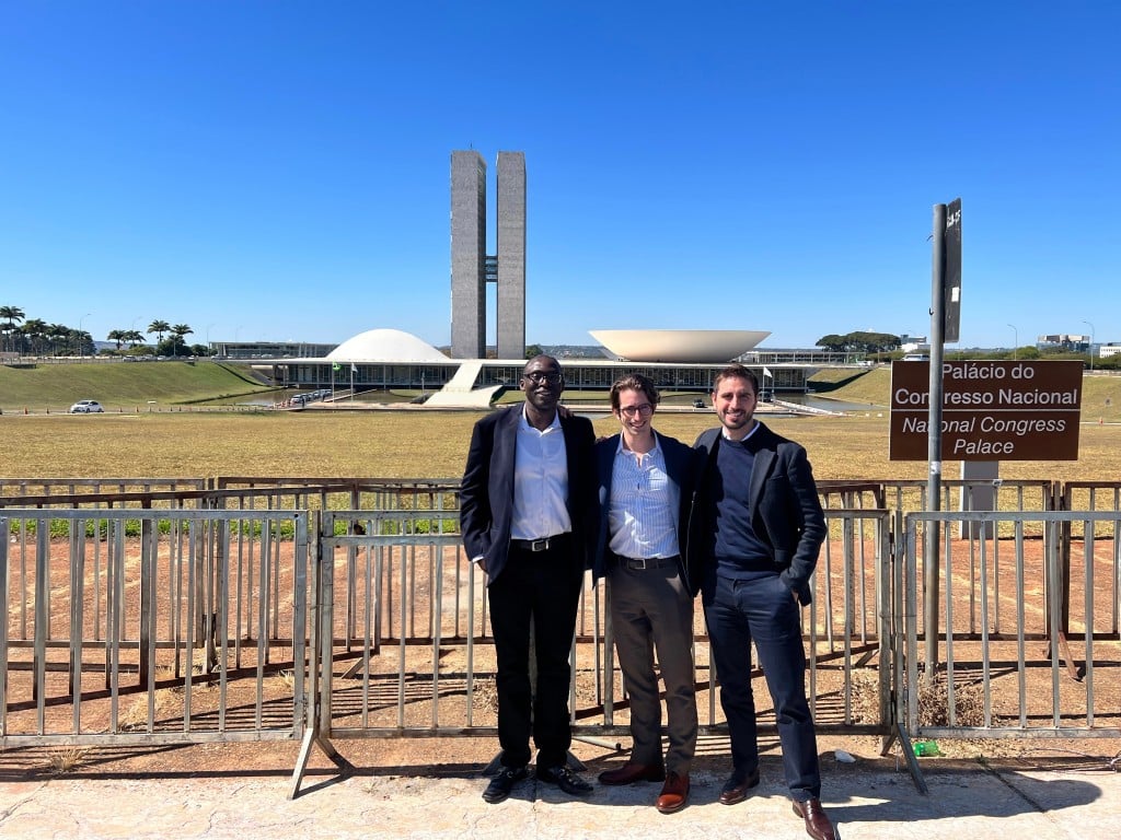 Three men with the statement